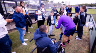 Jogadores do Corinthians interagindo com crianças da ONG Make-A-Wish Brasil