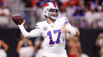 Josh Allen, quarterback do Buffalo Bills, em ação durante uma partida da NFL, buscando lançar a bola.