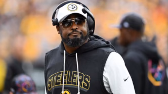 Mike Tomlin, técnico do Pittsburgh Steelers, em uma coletiva de imprensa, com semblante sério.